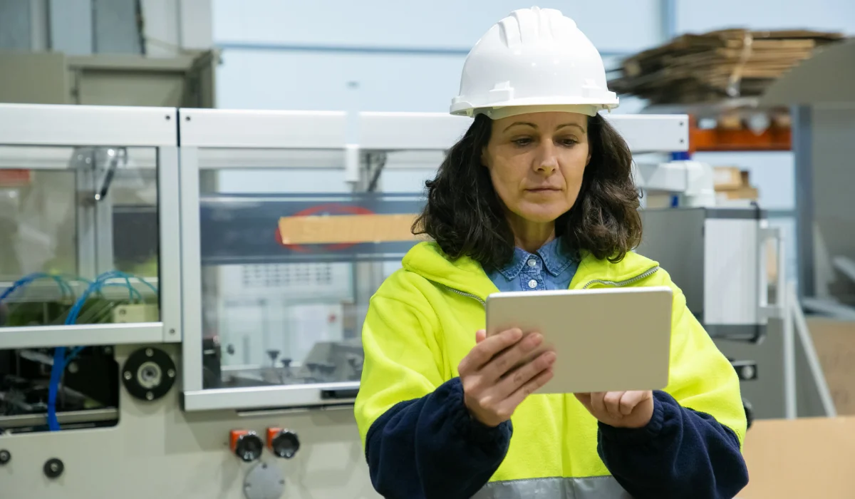 Female industrial worker using tablet computer on site