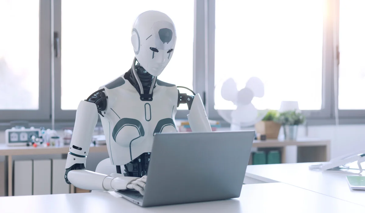 robot using laptop in office