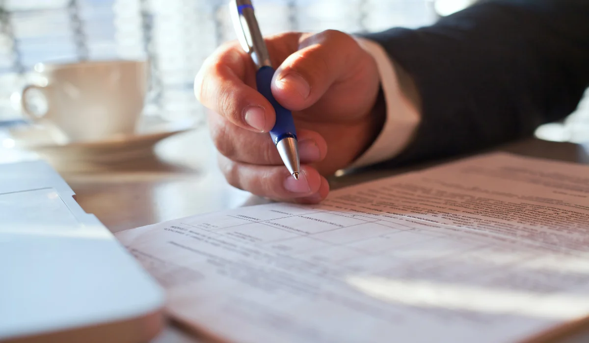 man signing a document
