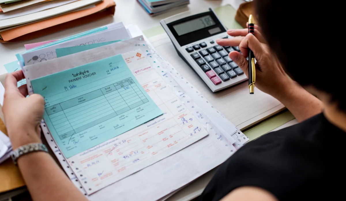 woman calculating expense through bills